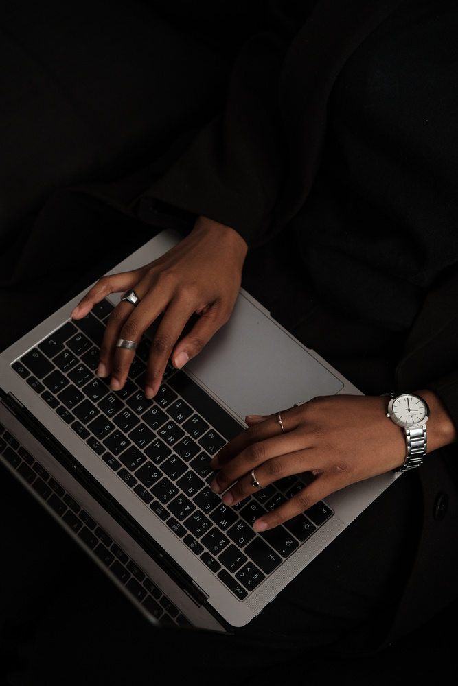 Woman Typing on Laptop